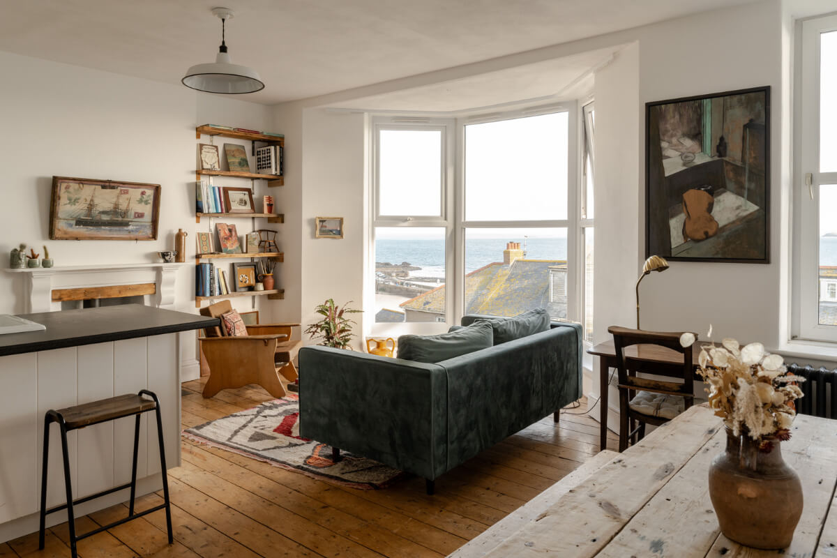 open plan living room bay window wooden floorboards