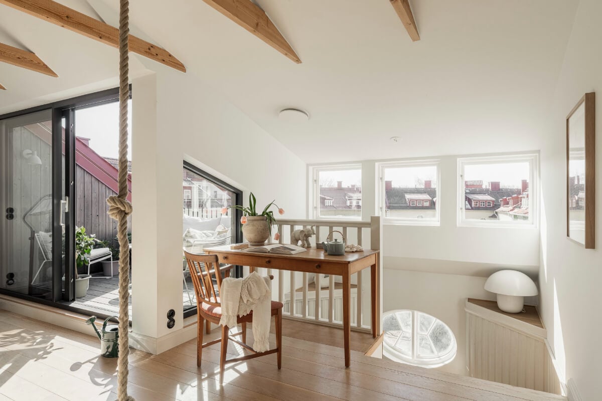 A Swedish Duplex Apartment Inspired by A Danish Summer House 8 open-plan top floor living space wooden beams