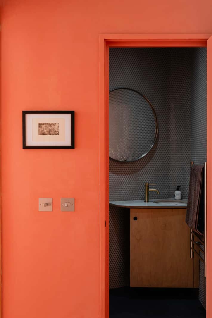 Bespoke Furniture in a Restored Seaside Apartment in England 14 orange wall bathroom