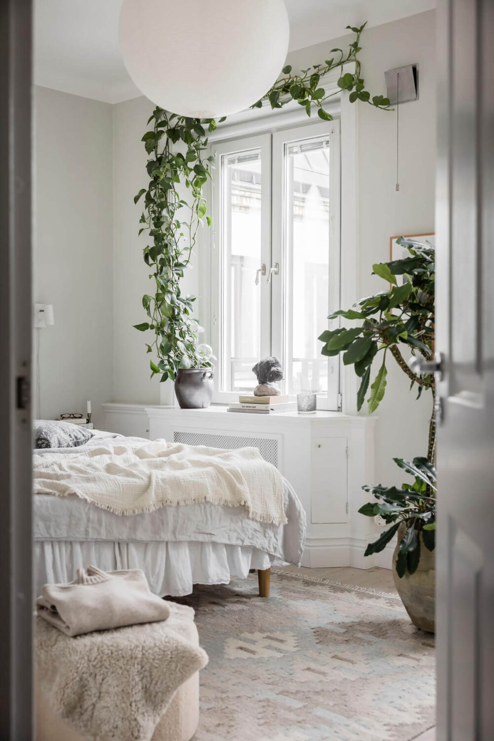 A Light Color Palette in a Stylish Renovated Late 19th Century Apartment 13 peek into bedroom