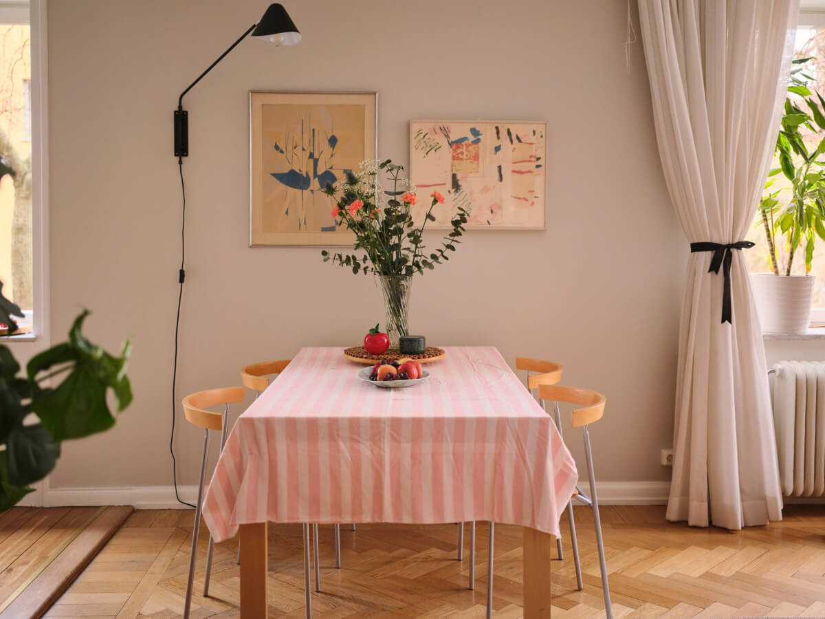 A Corner Apartment with Period Features and Bright Color Pops 7 pink striped tablecloth