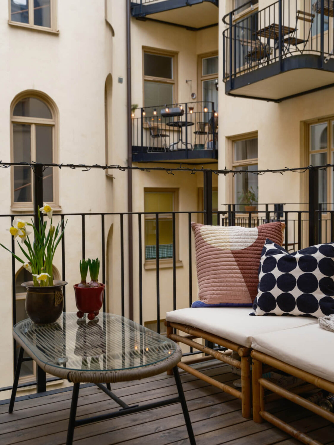 A Serene 19th Century Apartment with a Deep Red Kitchen 5 rattan balcony bench