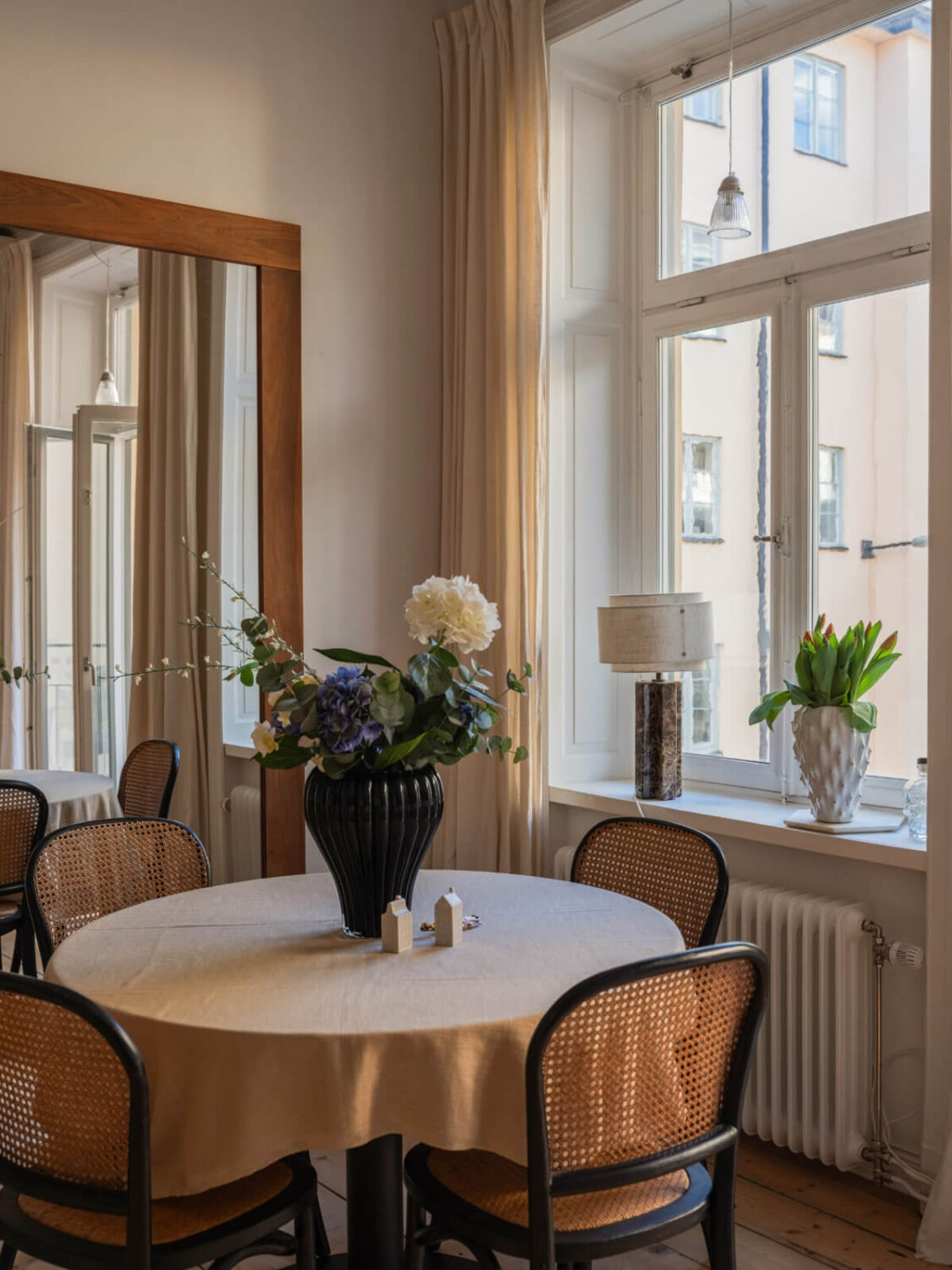 A Small Apartment with Contemporary Furniture in a 19th-Century Building 5 round dining table large mirror