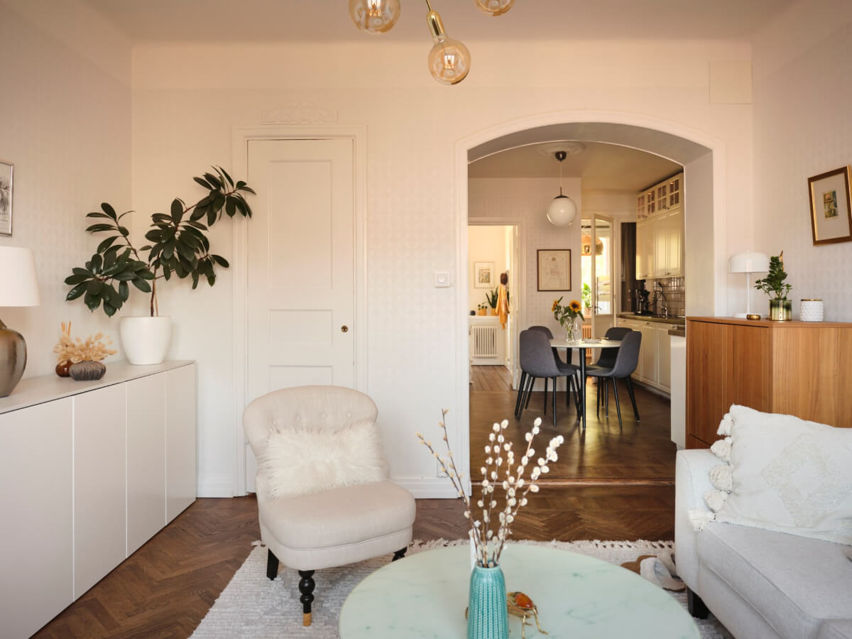 A Light-Filled 1920s Apartment with Two Spacious Balconies 2 semi-open-plan living room kitchen arched doorway