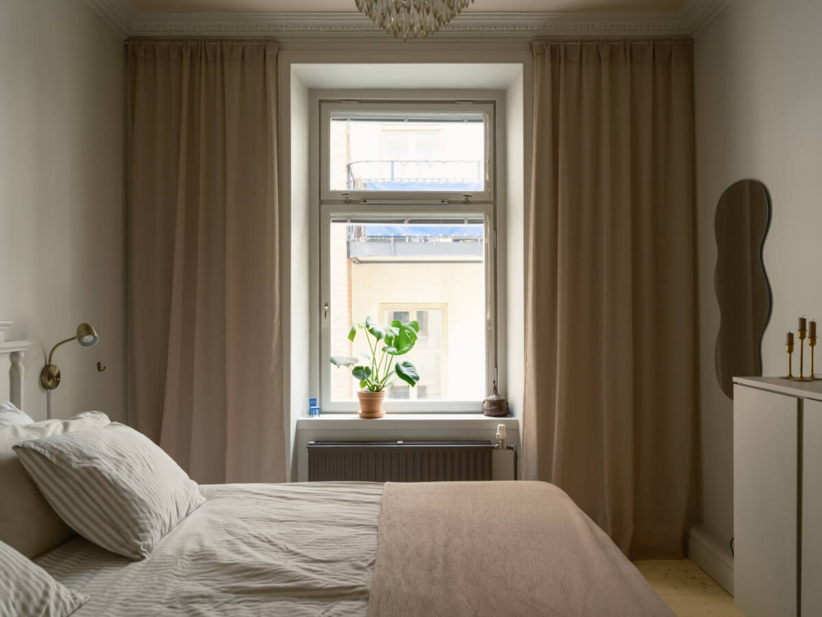 A Serene 19th Century Apartment with a Deep Red Kitchen 15 serene bedroom large window wavy mirror