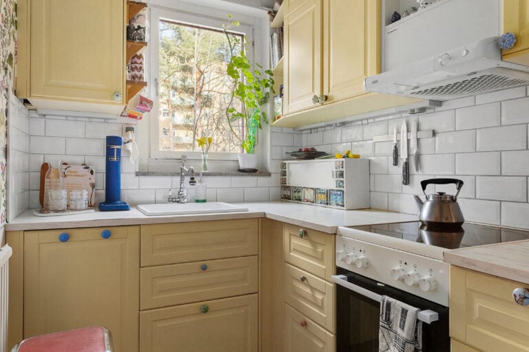 small yellow kitchen colorful knobs white subway tiles