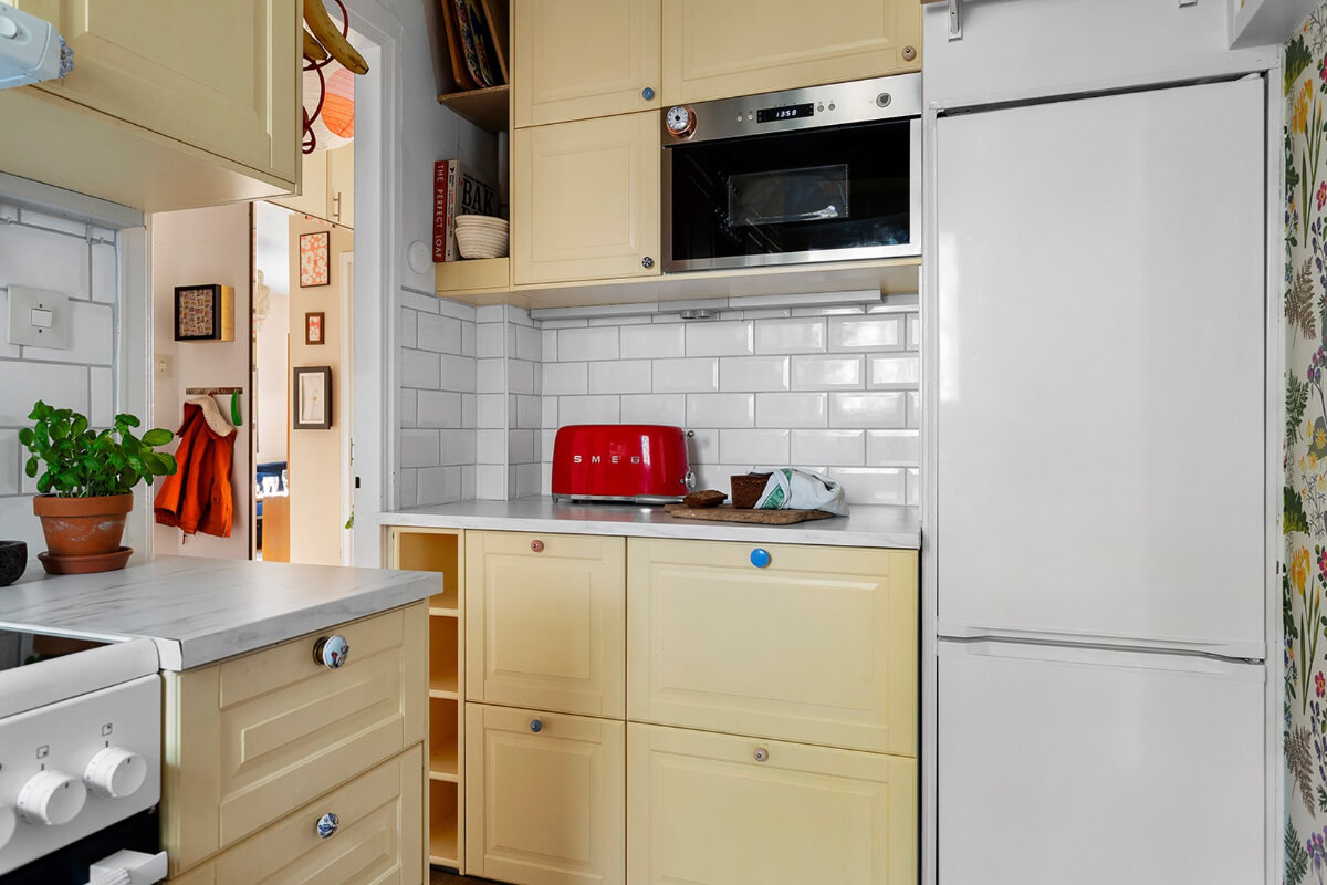 A Colorful 1940s Apartment in Stockholm 9 small yellow kitchen floral wallpaper