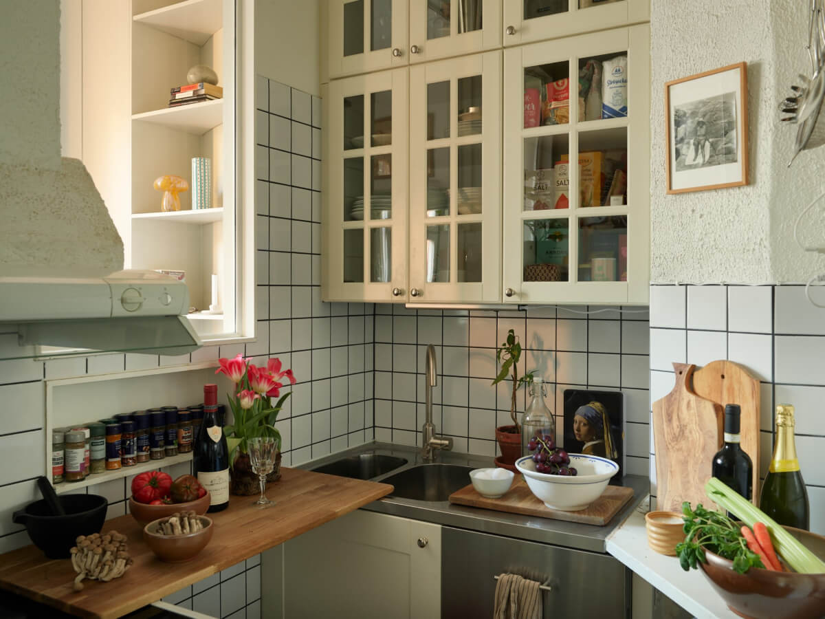 A Muted Color Palette and Smart Storage in a Small Stockholm Apartment 14 tiny kitchen glass doors shelf