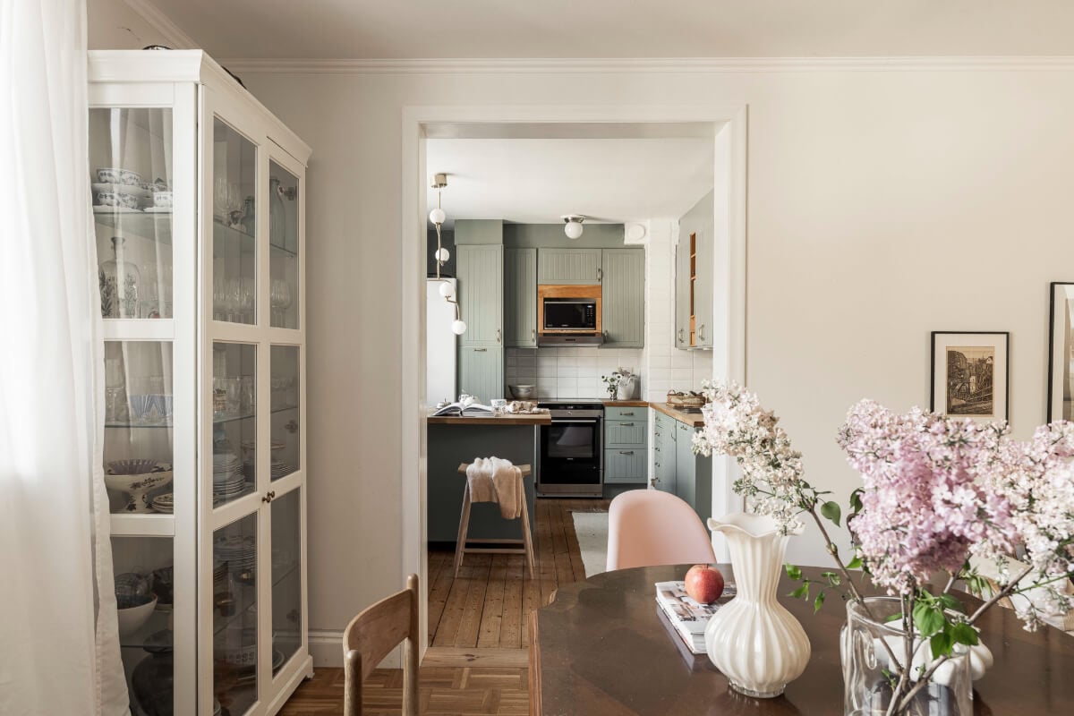 A Swedish Duplex Apartment Inspired by A Danish Summer House 21 view into green kitchen