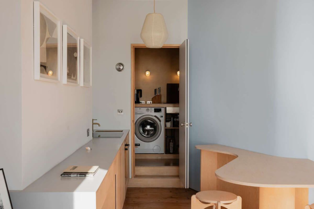 Bespoke Furniture in a Restored Seaside Apartment in England 9 view into laundry room