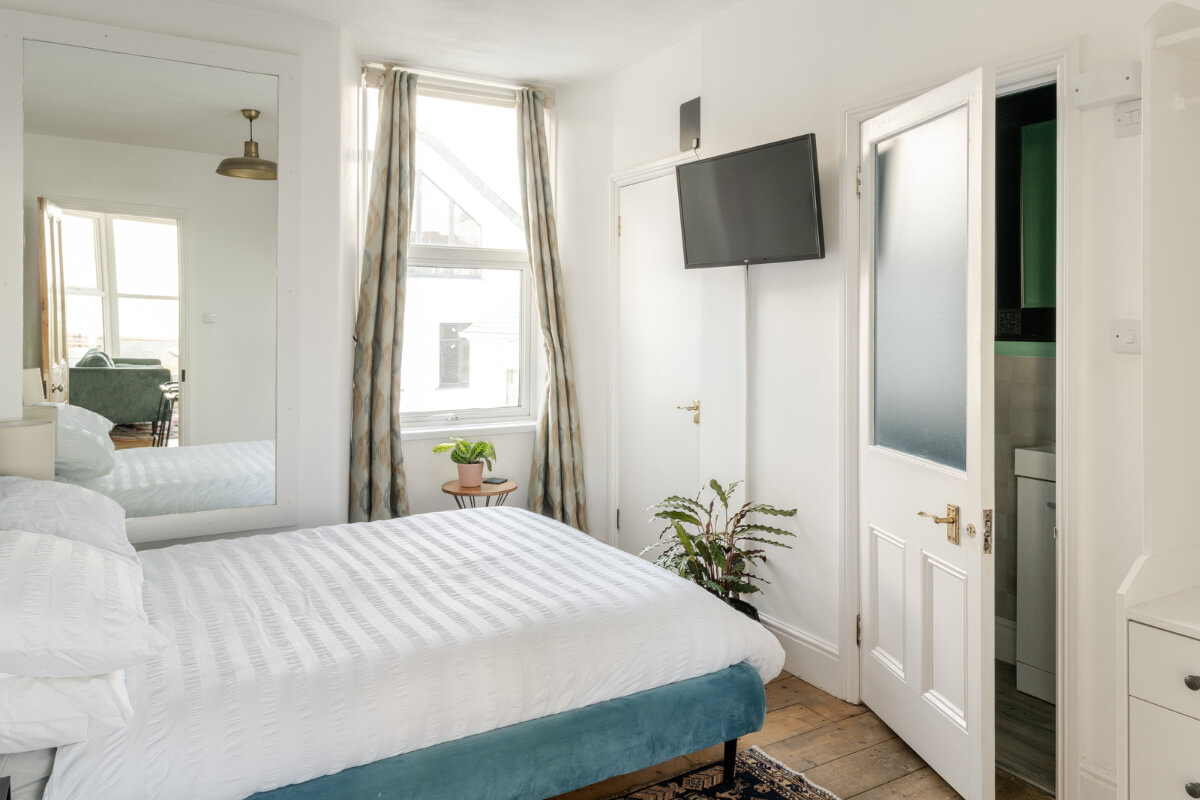 A Small Victorian Apartment by the Sea in Cornwall 11 white bedroom wooden floorboards