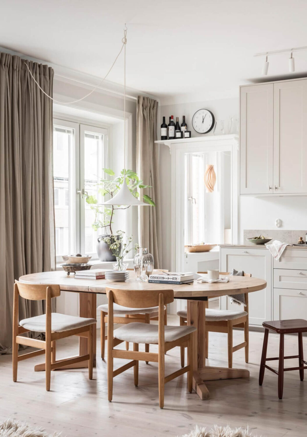 A Light Color Palette in a Stylish Renovated Late 19th Century Apartment 7 wooden dining table
