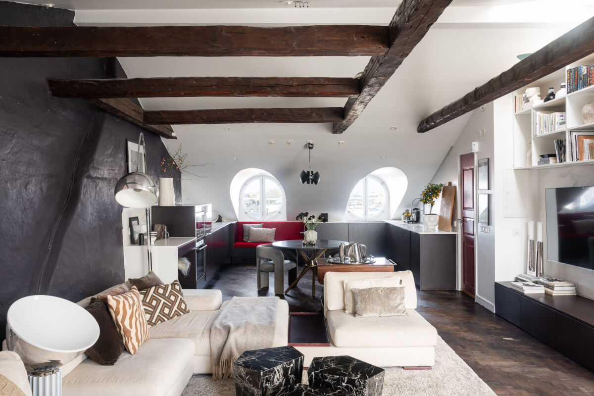 attic apartment exposed beams black wall A Stylish Black and White Penthouse Apartment in Stockholm
