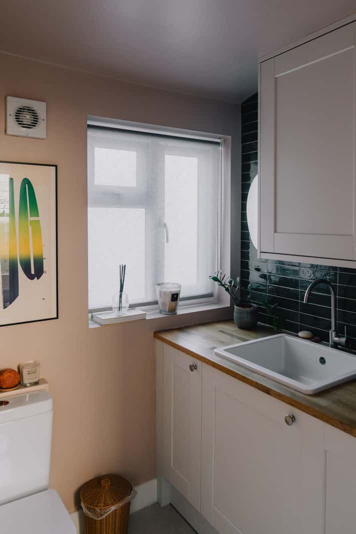 A Serene Color Palette and Built-In Shelves in a London Duplex 22 bathroom green tiles