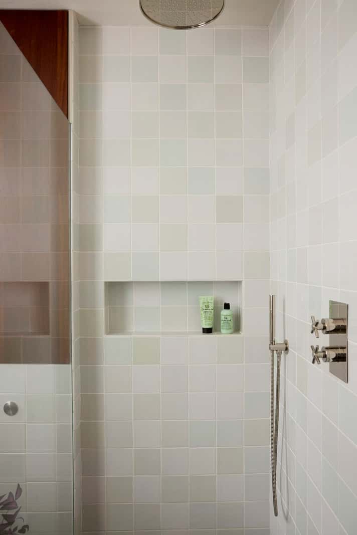 bathroom light colored tiles storage niche