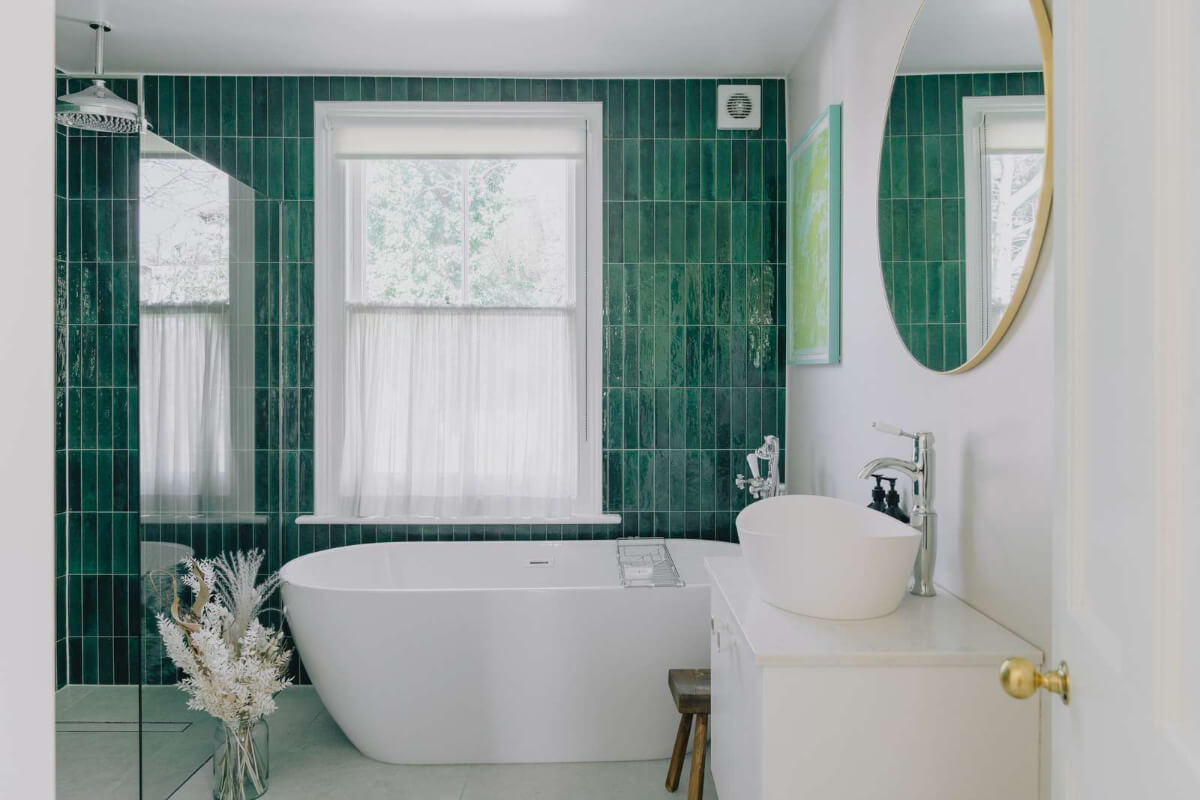 A Serene Color Palette and Built-In Shelves in a London Duplex 20 bathroom with shower and bath green tiles