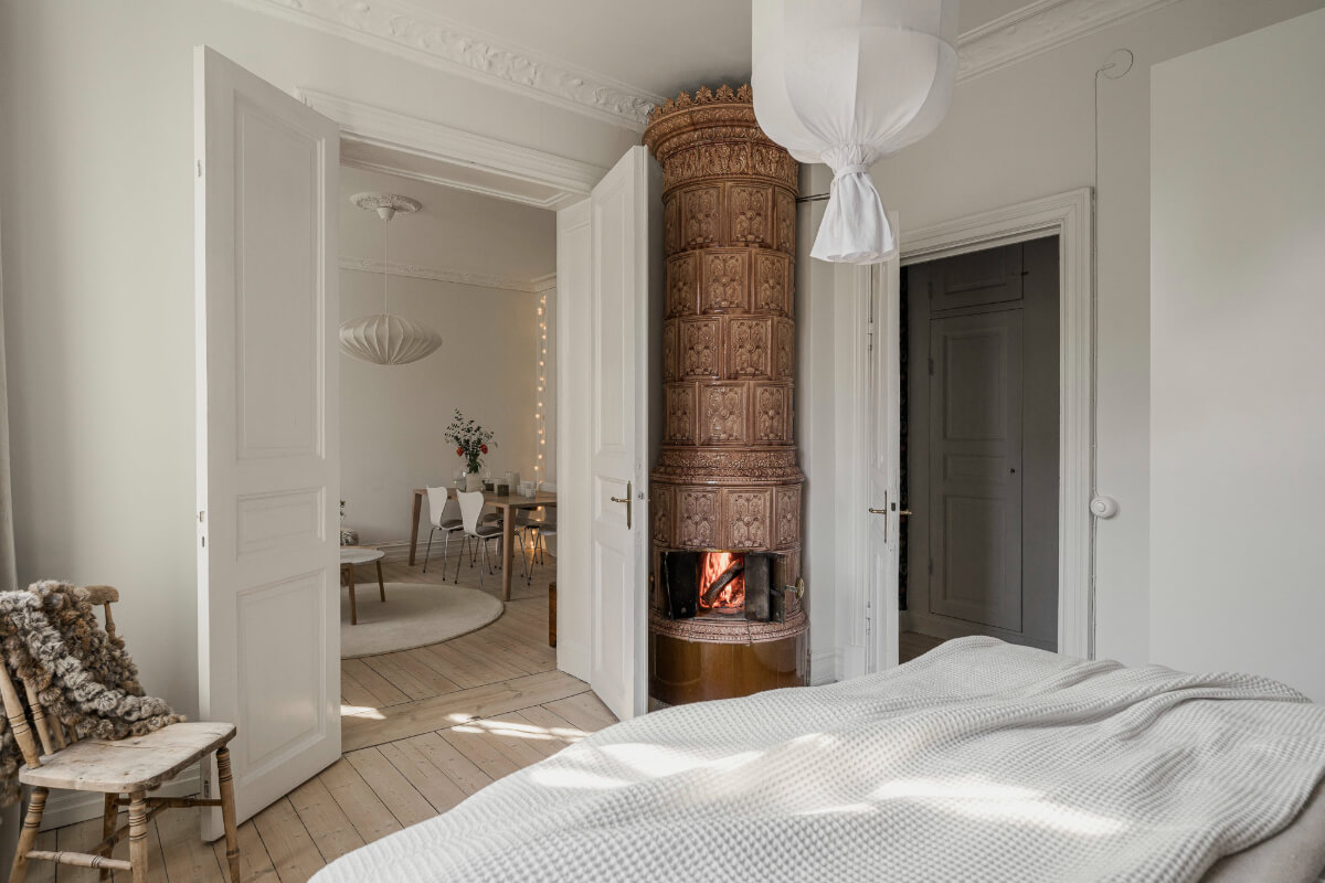 A Bright Swedish Apartment with Period Features and a Green Kitchen 21 bedroom double wooden doors fireplace