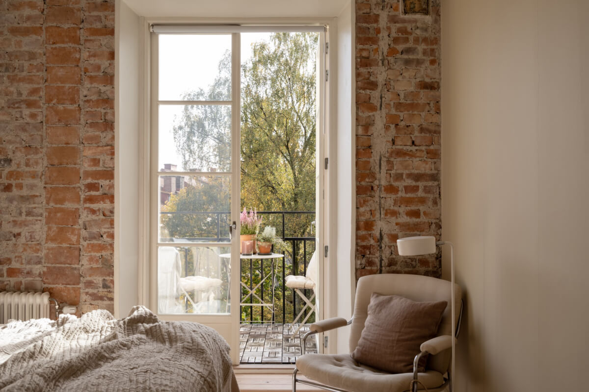 A Beige Color Palette and Built-in Bookshelves in a 1920s Apartment 14 bedroom exposed brick wall balcony