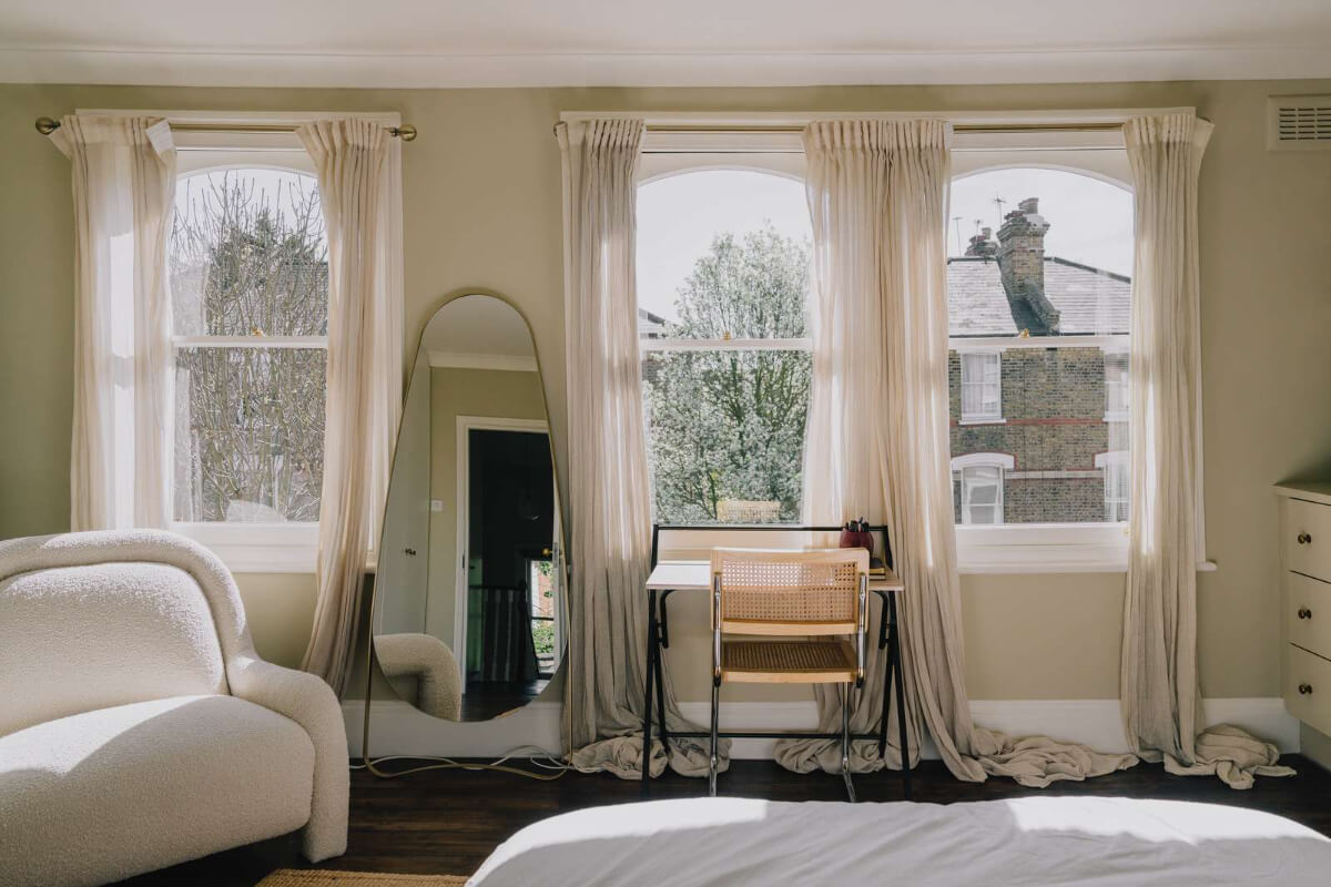 A Serene Color Palette and Built-In Shelves in a London Duplex 16 bedroom large arched windows