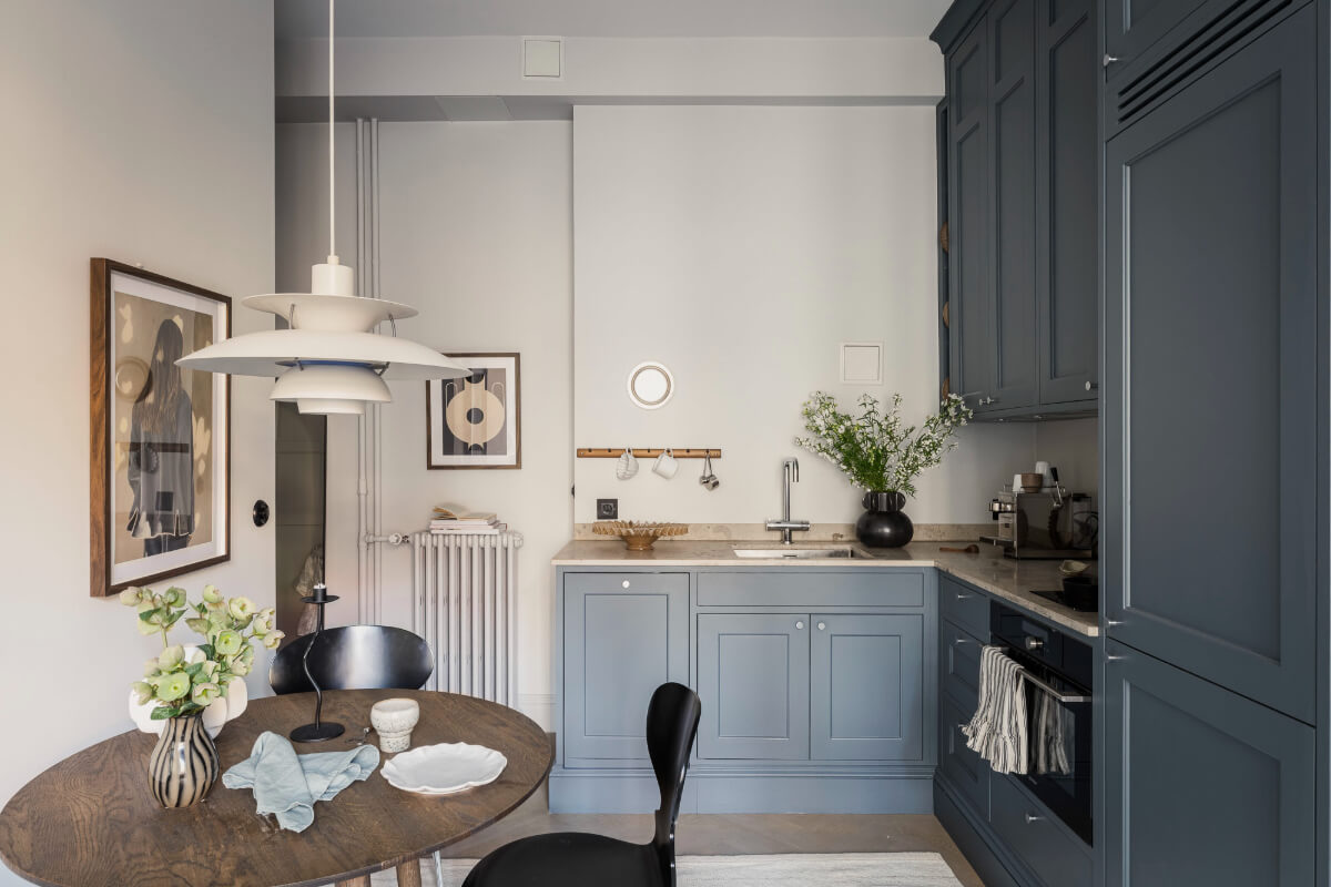 blue kitchen with round wooden table