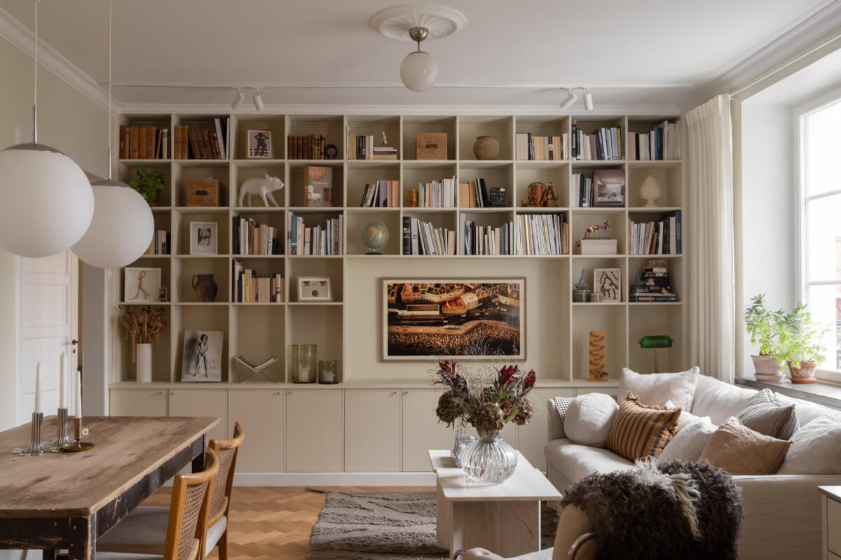 A Beige Color Palette and Built-in Bookshelves in a 1920s Apartment 1 built-in bookshelves living room
