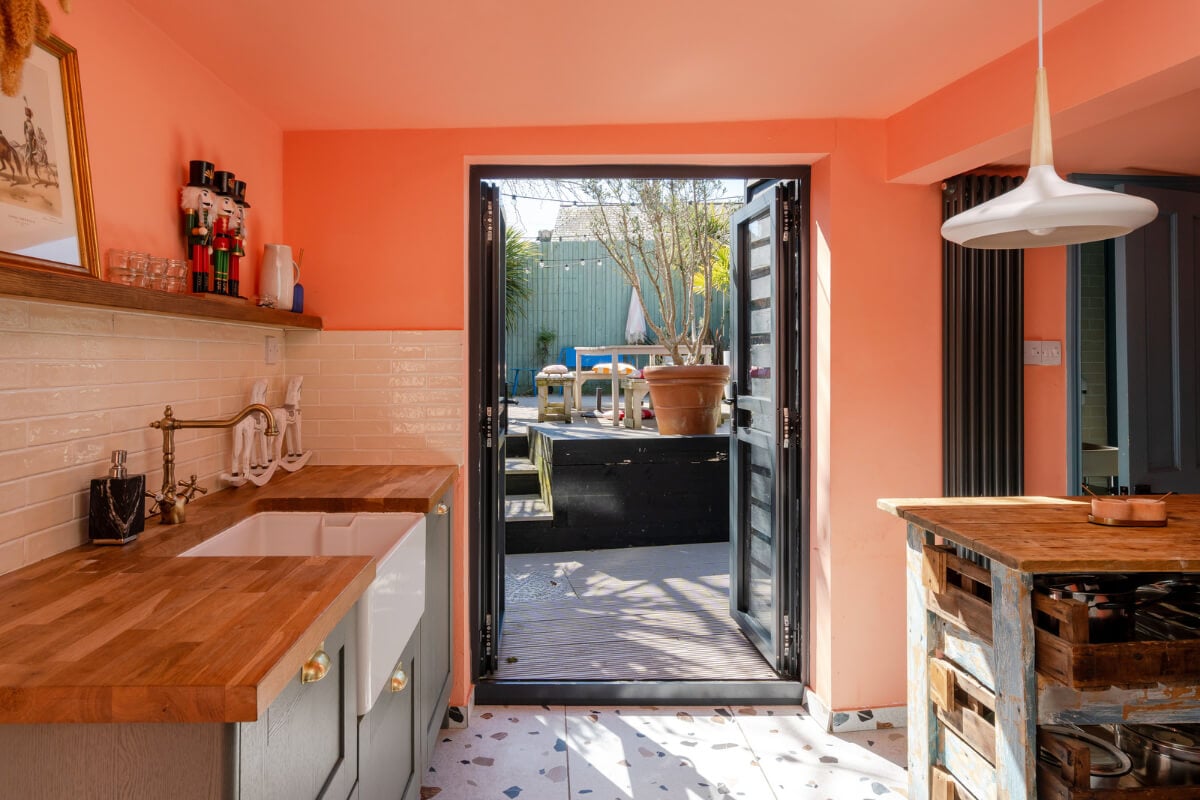 Colorful Design and Historic Features in a Charming English Home 2 coral kitchen with terrazzo tiles nordroom