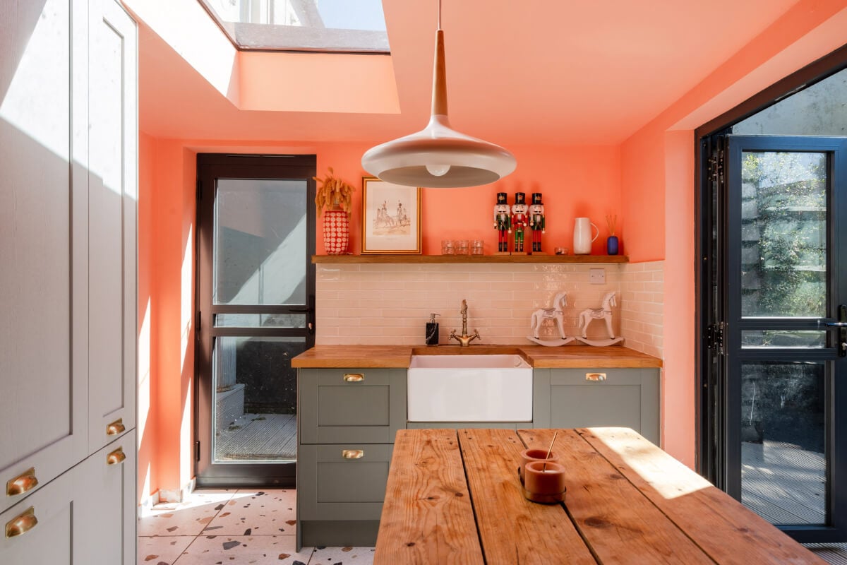 Colorful Design and Historic Features in a Charming English Home 3 coral wall skylight kitchen terrazzo tile rustic wooden table nordroom