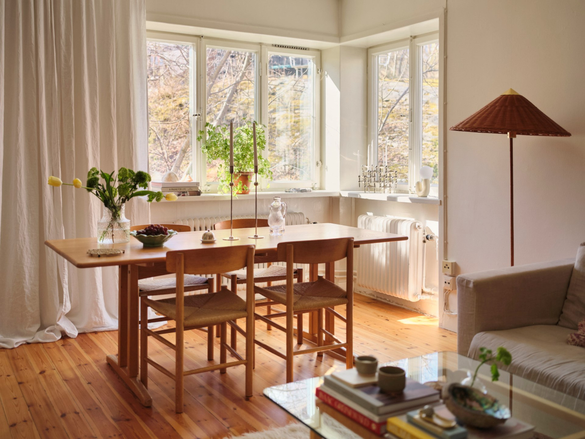 A Light-Filled Functionalist Apartment in Stockholm 4 corner window light living room dining table