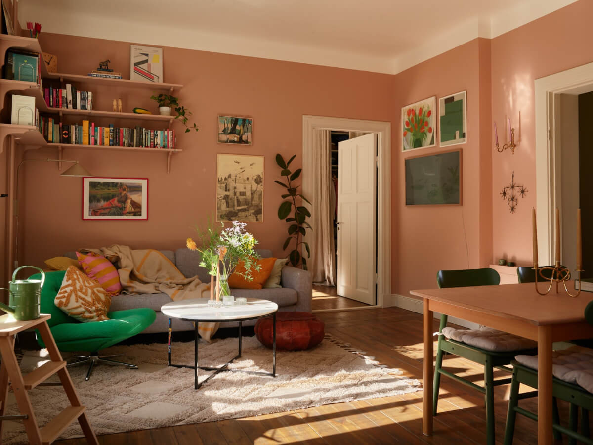 dark beige walls living room wooden floorboards bookshelves