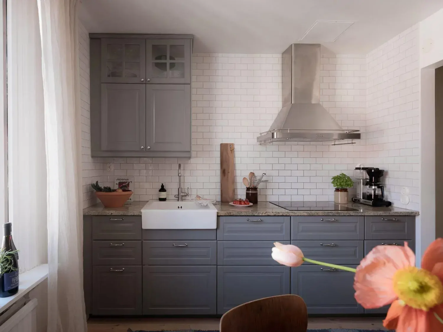 Gray Walls in a Renovated 19th-Century Gothenburg Apartment 17 dark gray kitchen cabinets with white backsplash tiles
