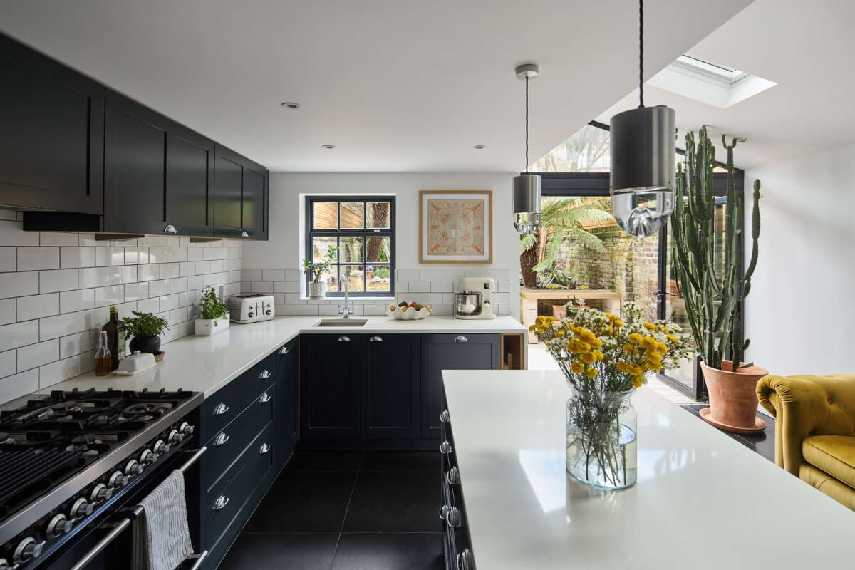 Light and Dark in a Spacious Victorian Townhouse in London 11 dark kitchen with island metro backsplash tiles