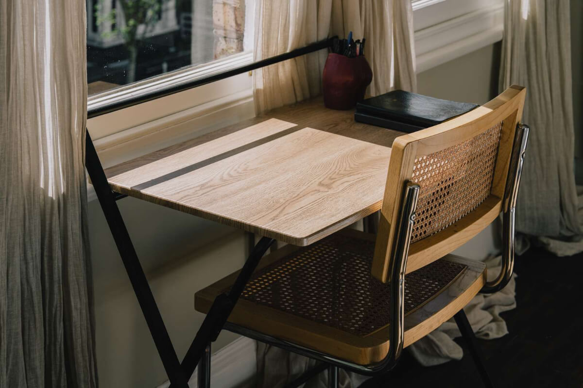 A Serene Color Palette and Built-In Shelves in a London Duplex 17 desk in front of window
