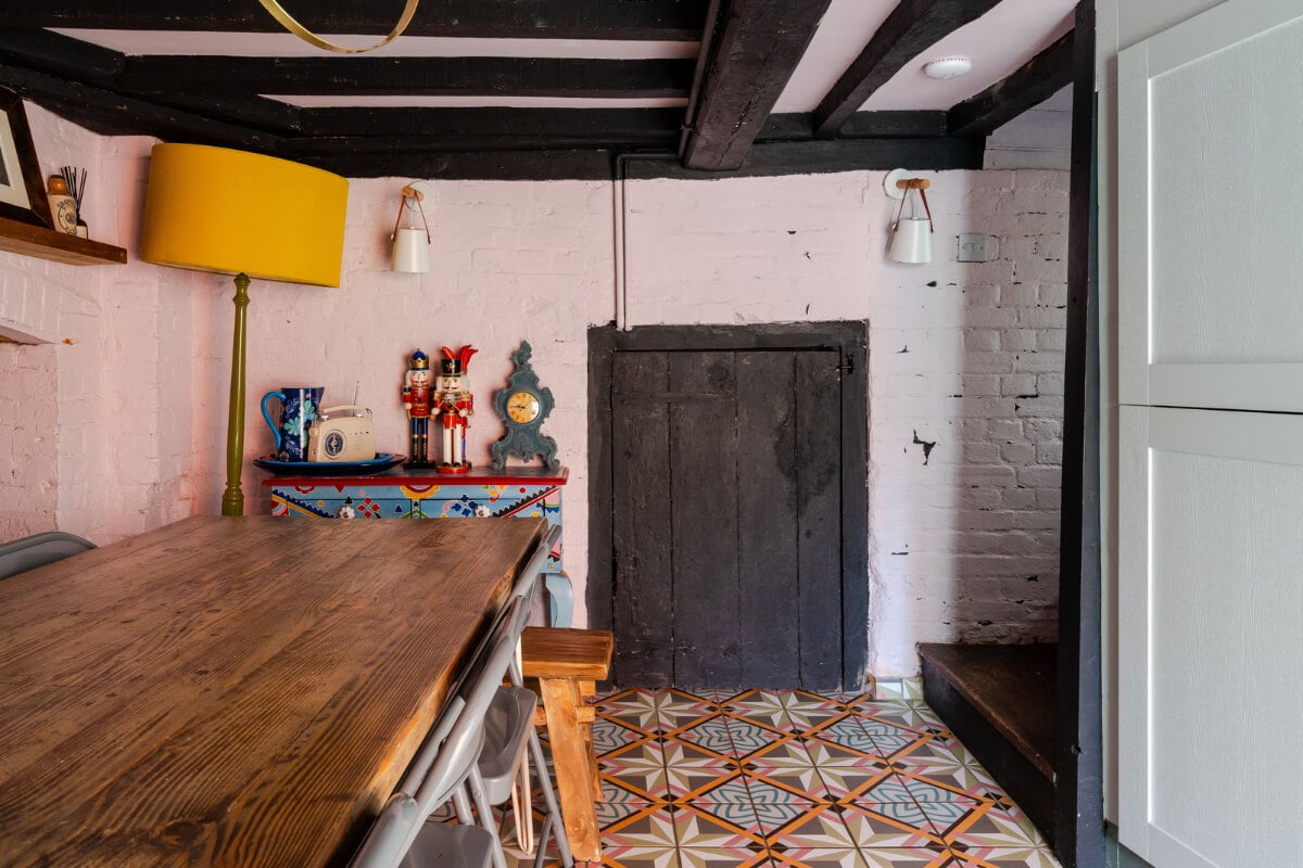 Colorful Design and Historic Features in a Charming English Home 4 dining room white painted brick walls wooden beams colorful floor tiles nordroom