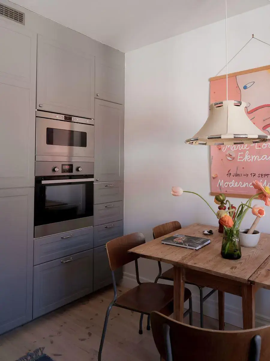 Gray Walls in a Renovated 19th-Century Gothenburg Apartment 18 floor to ceiling kitchen cabinets and wooden table