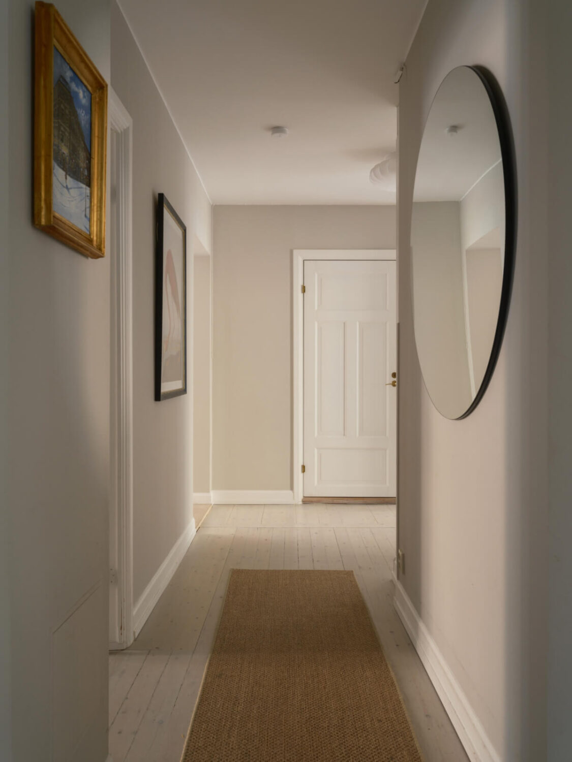 A Muted Palette and a Cozy Kitchen Breakfast Nook in a Swedish Apartment 20 gray hall round mirror