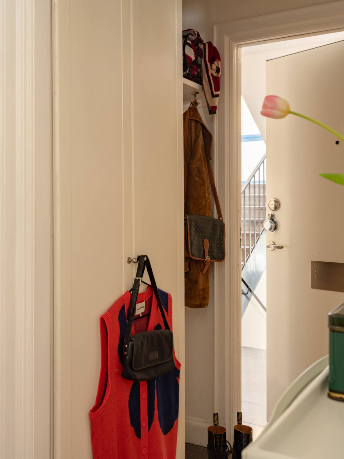 hall built in wardrobes small niche for coats and shoes A Small, Cozy Apartment with Built-in Storage and Bookshelves