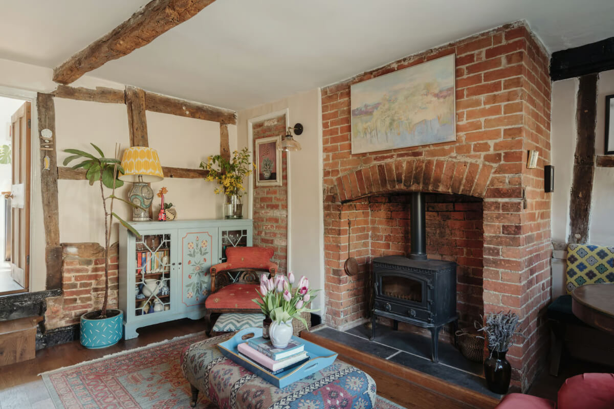 historic english cottage living room brick fireplace exposed beams