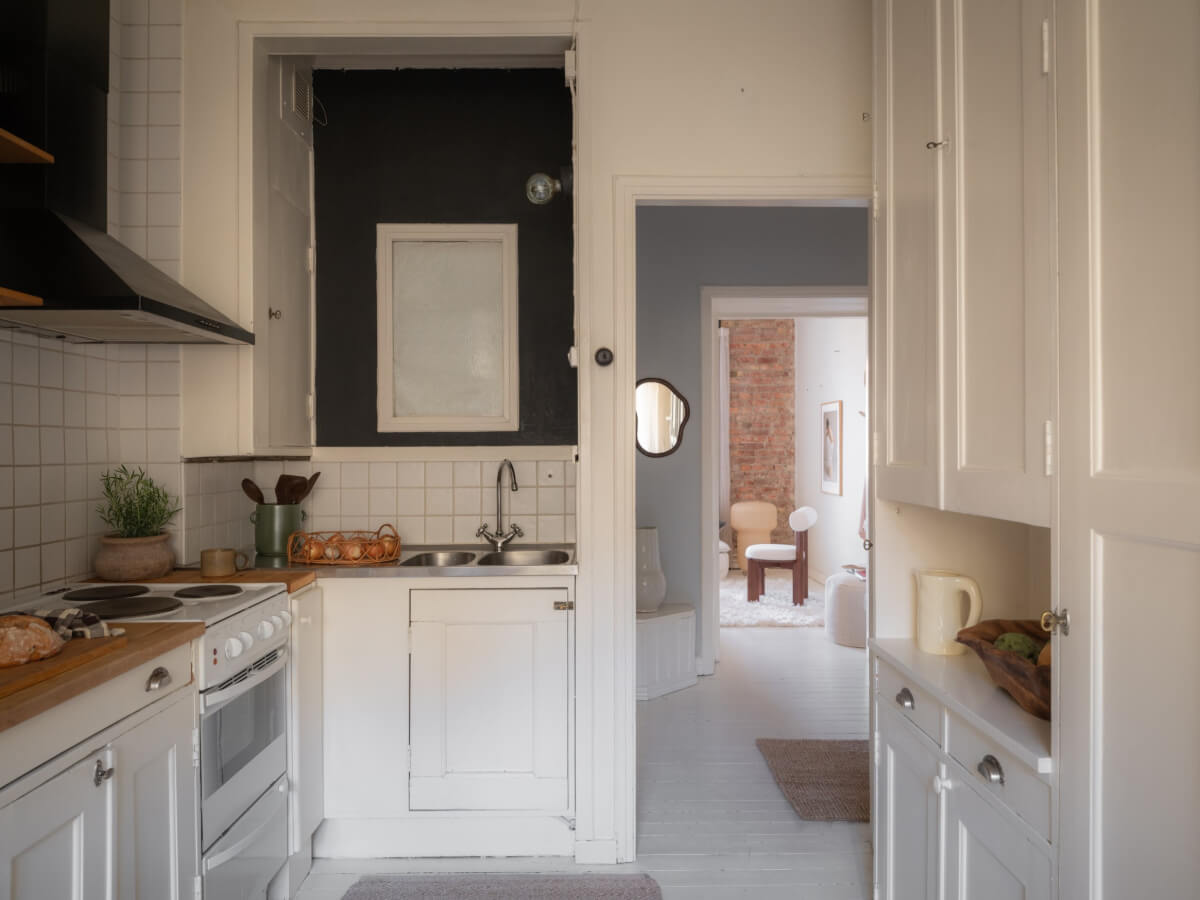 A Light-Colored Studio Apartment with a Cozy Kitchen 13 kitchen original cabinets