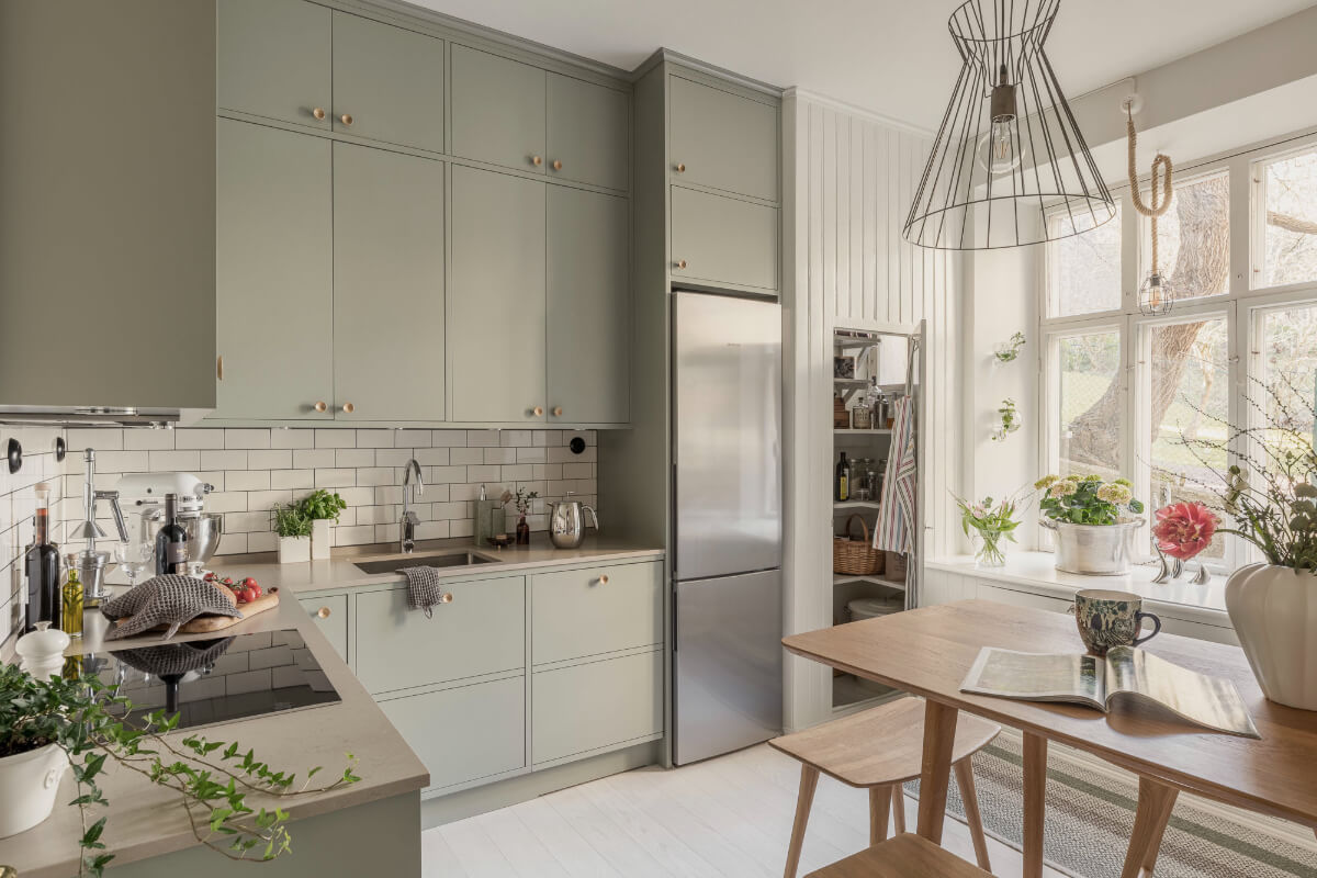 A Bright Swedish Apartment with Period Features and a Green Kitchen 5 kitchen pantry