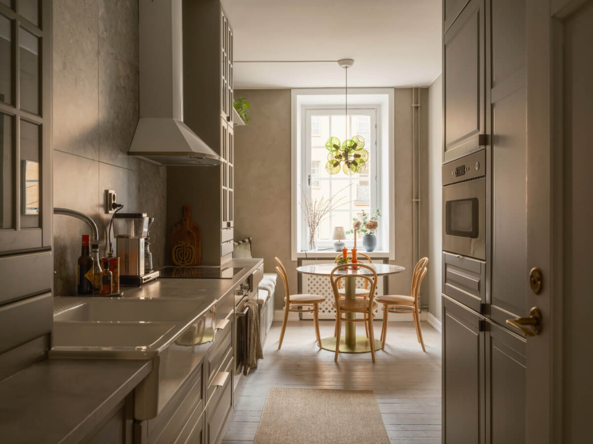 A Muted Palette and a Cozy Kitchen Breakfast Nook in a Swedish Apartment 9 kitchen with dining table and bench