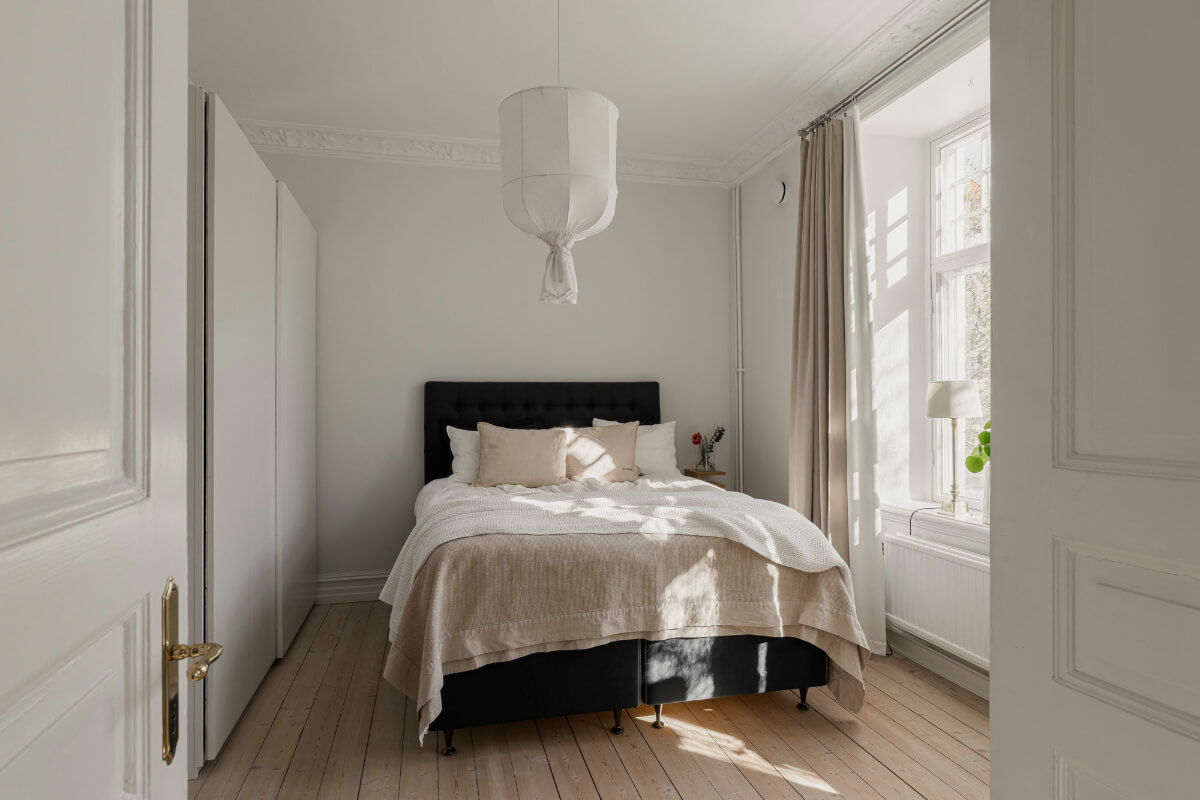 A Bright Swedish Apartment with Period Features and a Green Kitchen 17 light bedroom wooden floorboards