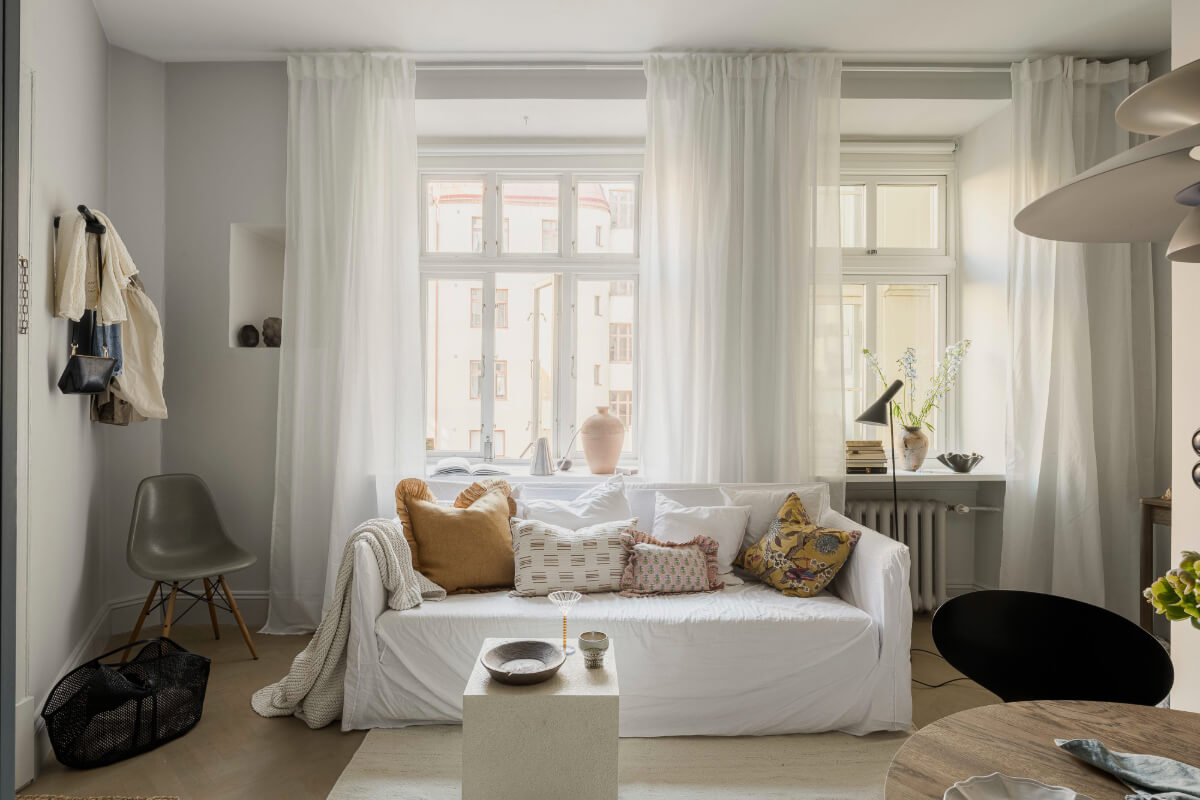 light gray living room large window white sofa