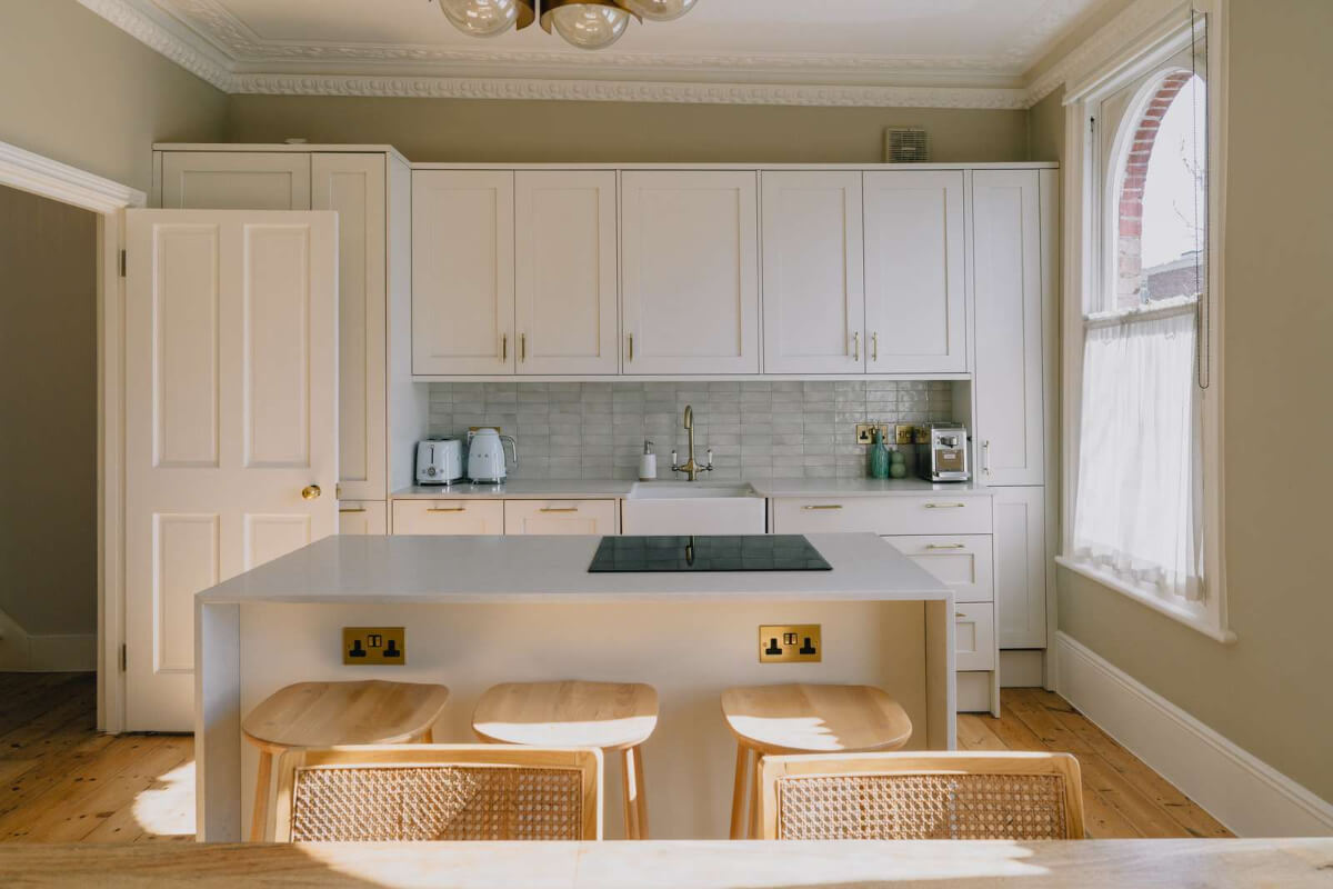A Serene Color Palette and Built-In Shelves in a London Duplex 8 light kitchen arched window butler sink