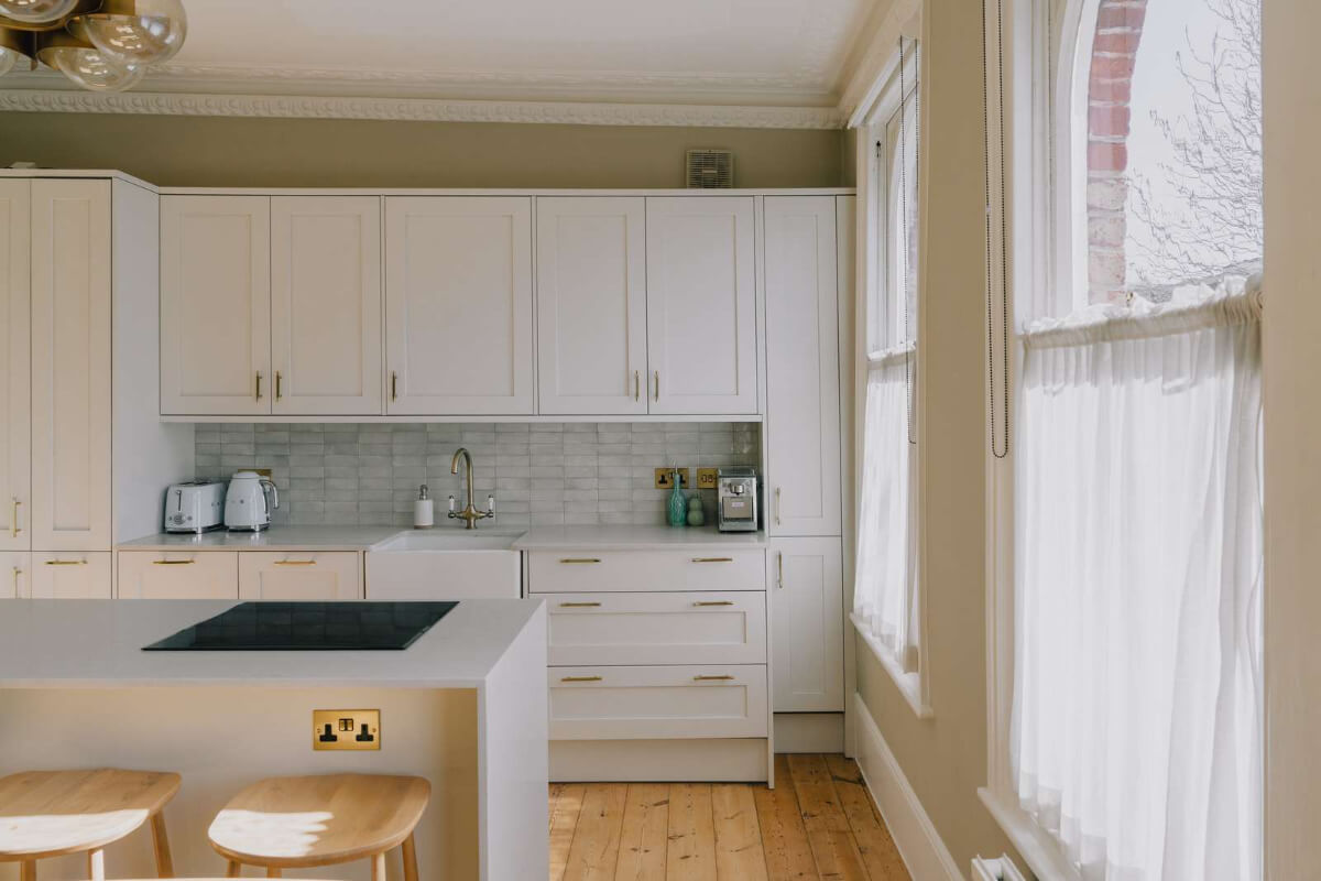 A Serene Color Palette and Built-In Shelves in a London Duplex 9 light kitchen brass fittings wooden floor