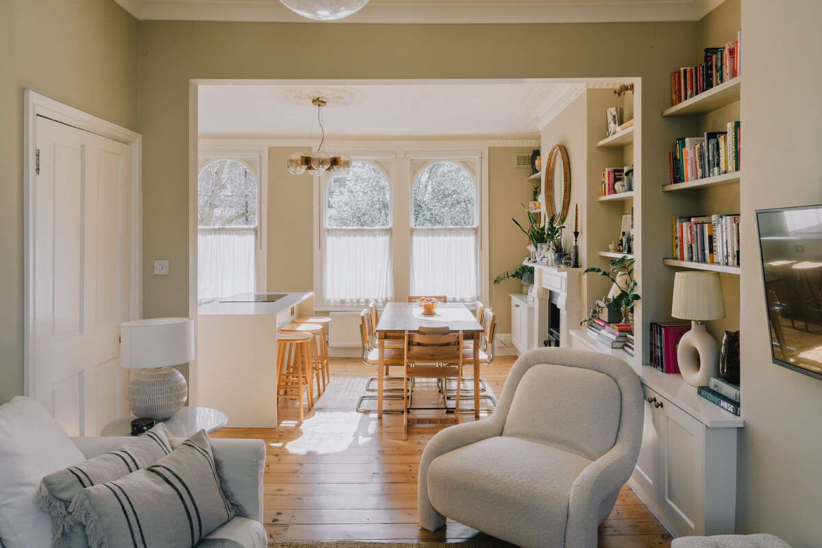 A Serene Color Palette and Built-In Shelves in a London Duplex 4 light open plan living space arched windows wooden floorboards