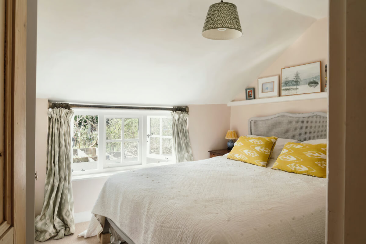 light pink walls cottage bedroom low window