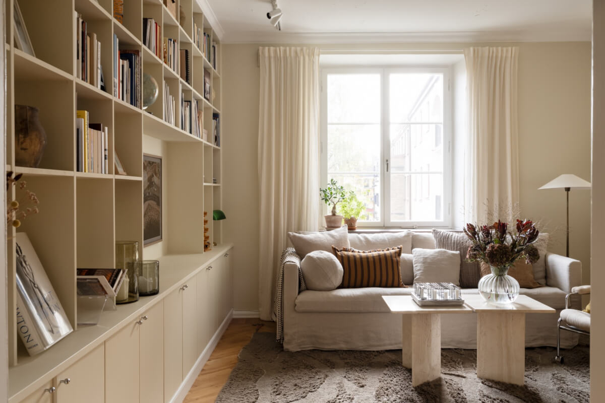 A Beige Color Palette and Built-in Bookshelves in a 1920s Apartment 2 living room built-in bookshelves