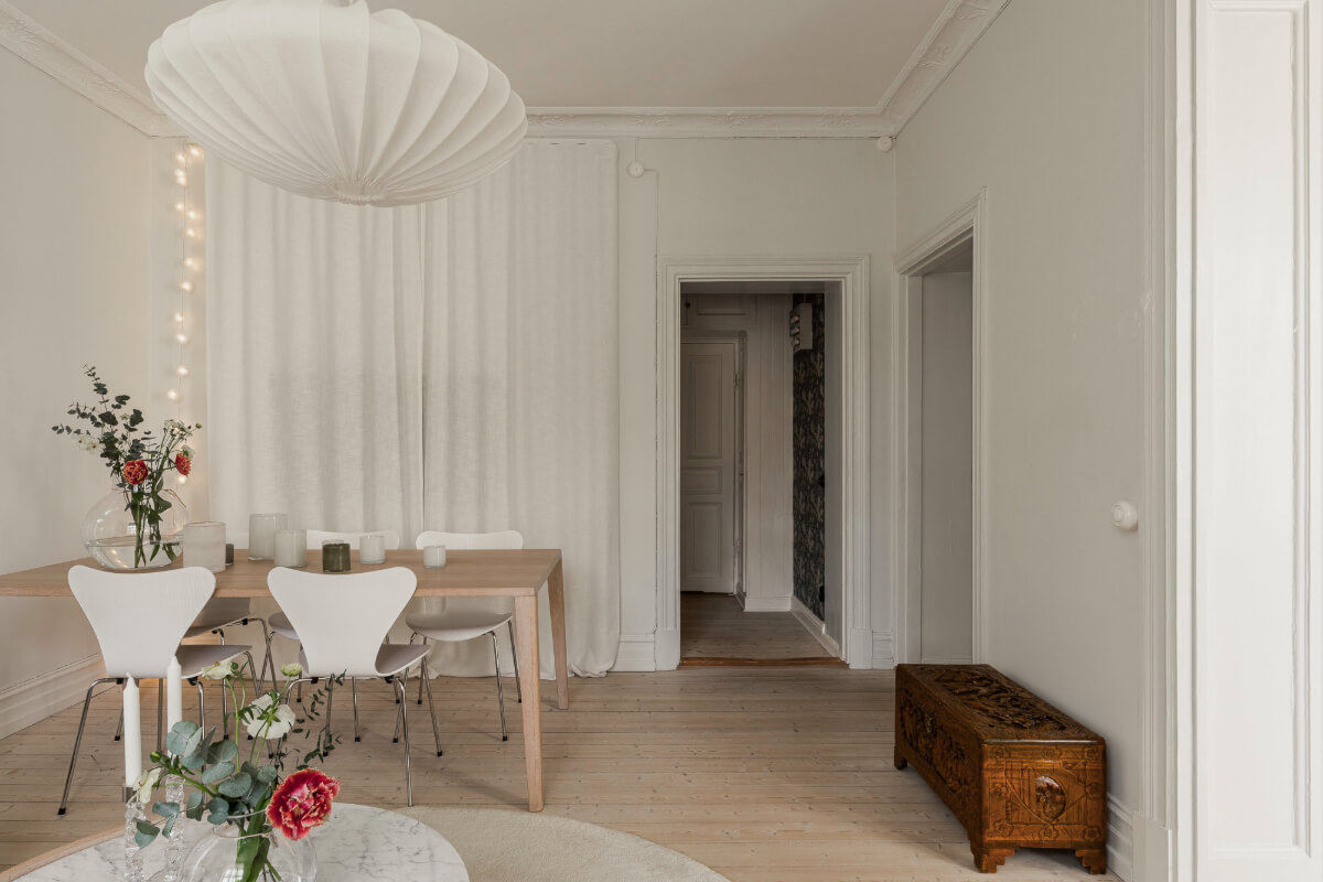 A Bright Swedish Apartment with Period Features and a Green Kitchen 13 living room storage behind curtain