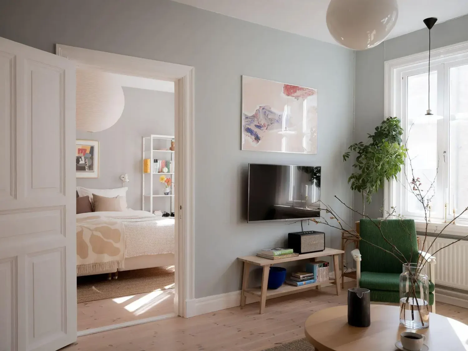 Gray Walls in a Renovated 19th-Century Gothenburg Apartment 7 living-room-with-door-to-bedroom.webp