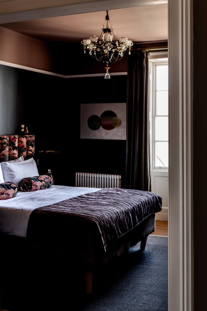 A Grand Georgian Home with Views of the Jurassic Coast 13 moody bedroom floral headboard